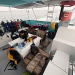 Dive boat deck loaded with scuba gear and ocean debris