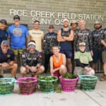 Group posing with plant baskets at Rice Creek Field Station SUNY Oswego